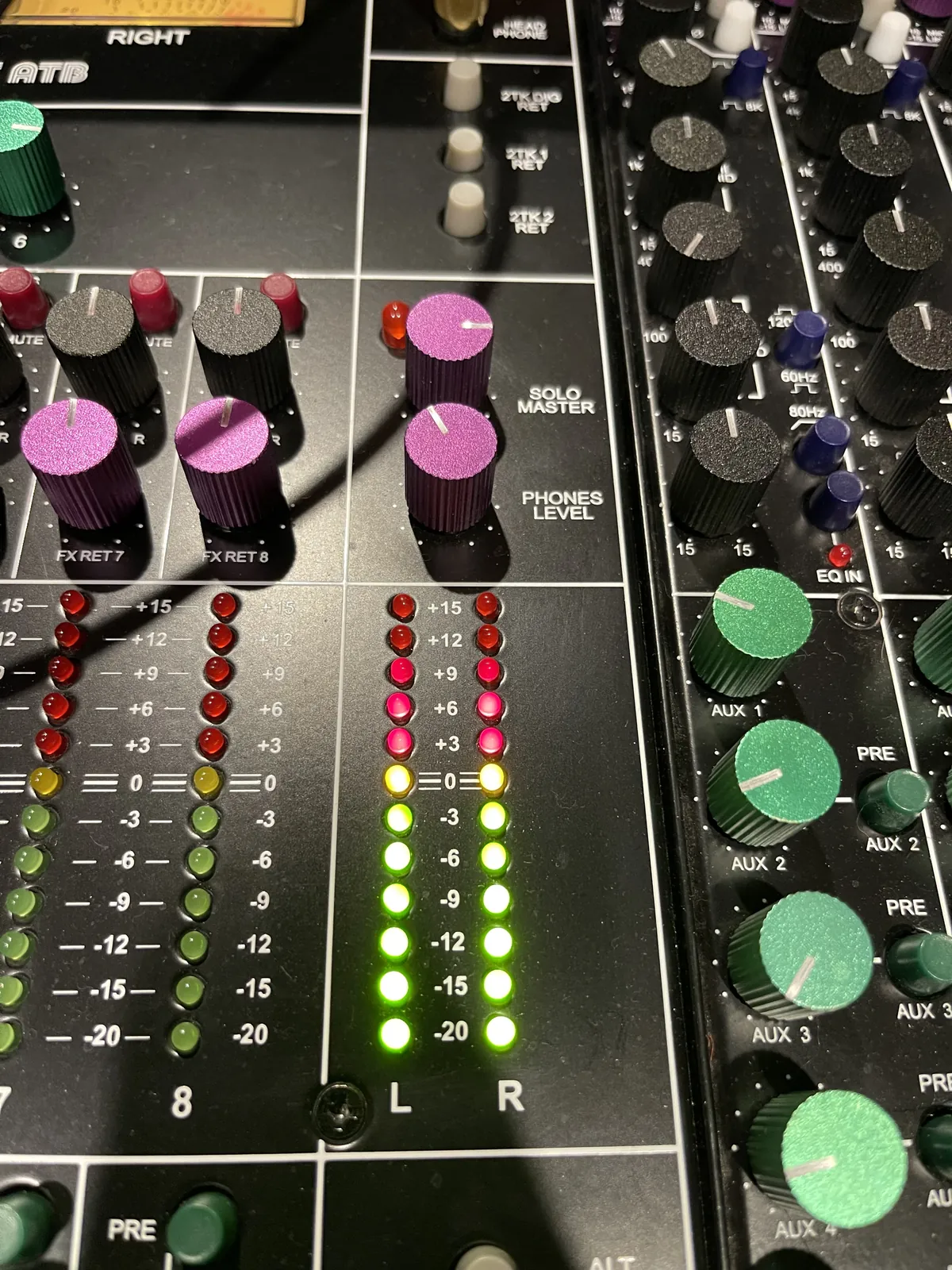 Meters and outboard gear during a mastering session at MidWav Studio